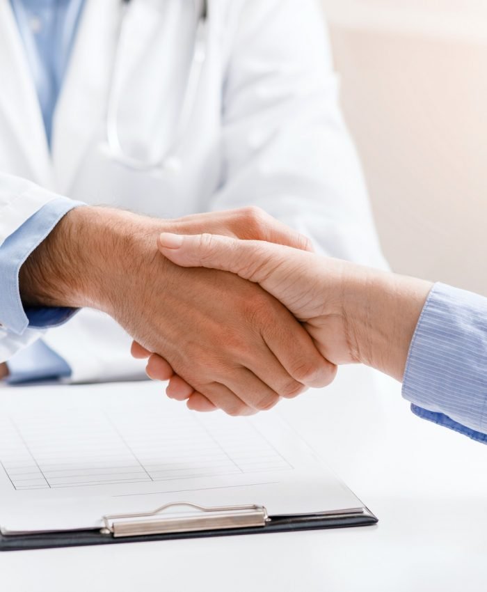 Senior female patient shaking hands with doctor Senior female patient shaking hands with doctor